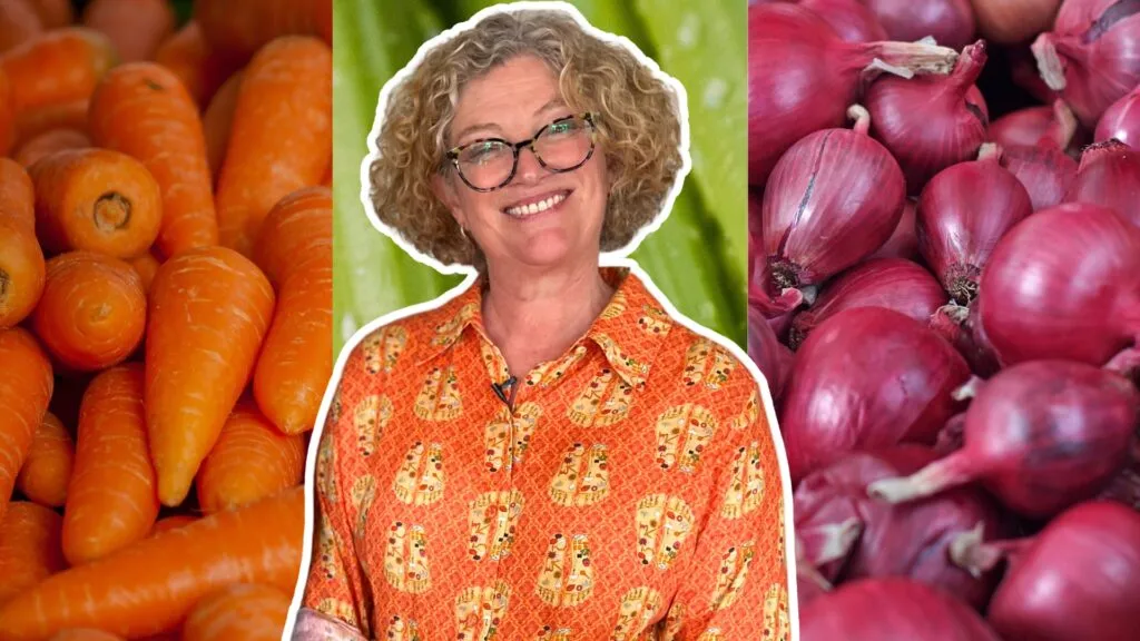 Vicky in front of a backdrop of vegetables.